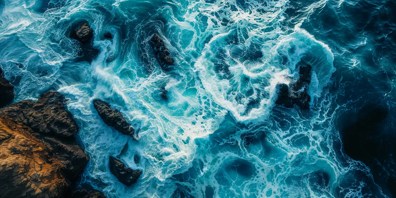 Aerial view of ocean waves and rocky coastline symbolizing environmental risk management and pollution liability insurance from Tellus Edge.